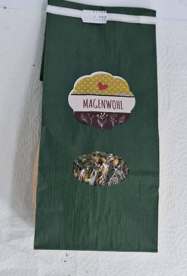 Kräutertee "Magenwohl" in grüner Verpackung mit Sichtfenster auf die Inhaltsstoffe.